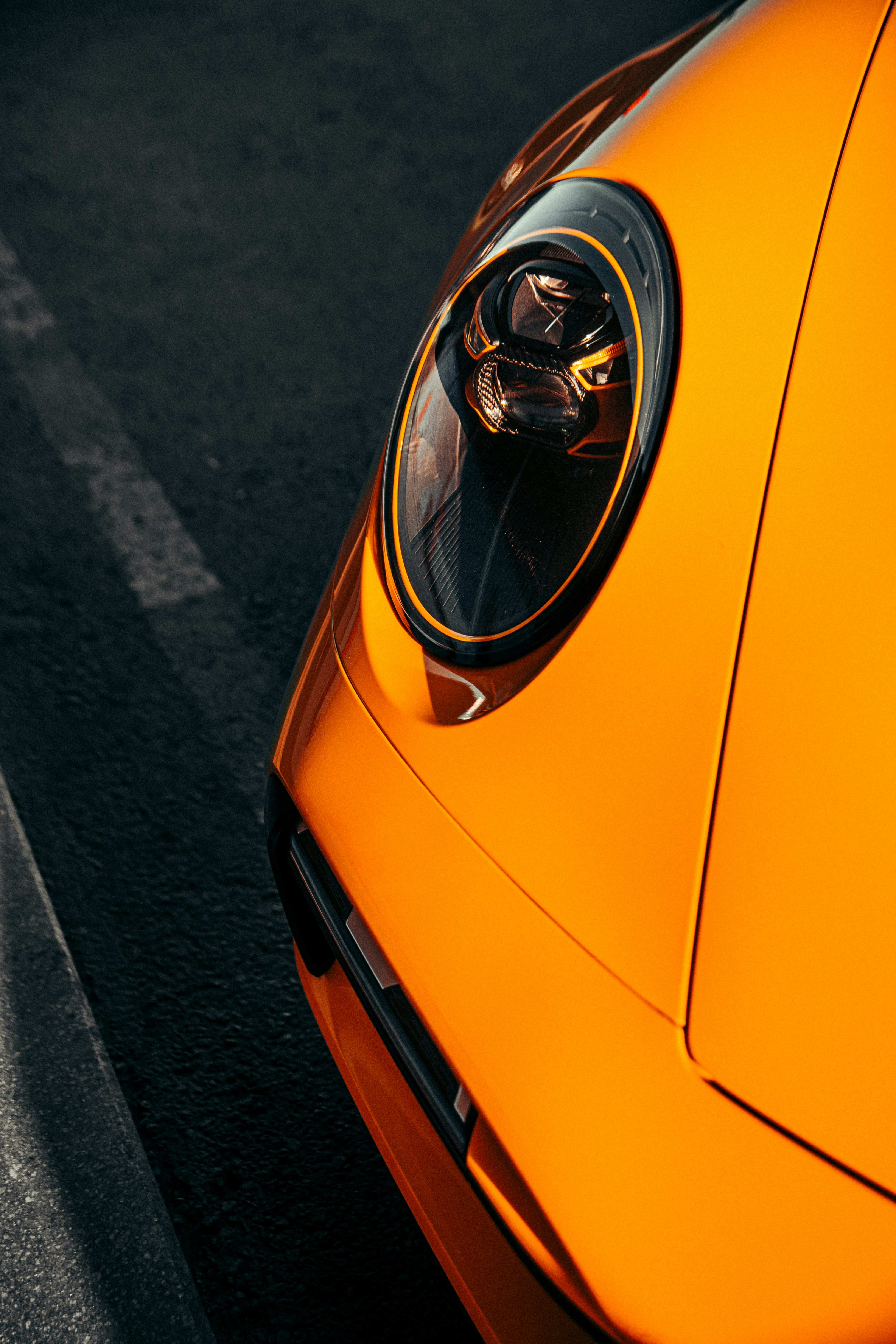 a close up of an orange sports car