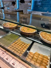 A warm kitchen scene showing baklava being carefully prepared by hand.