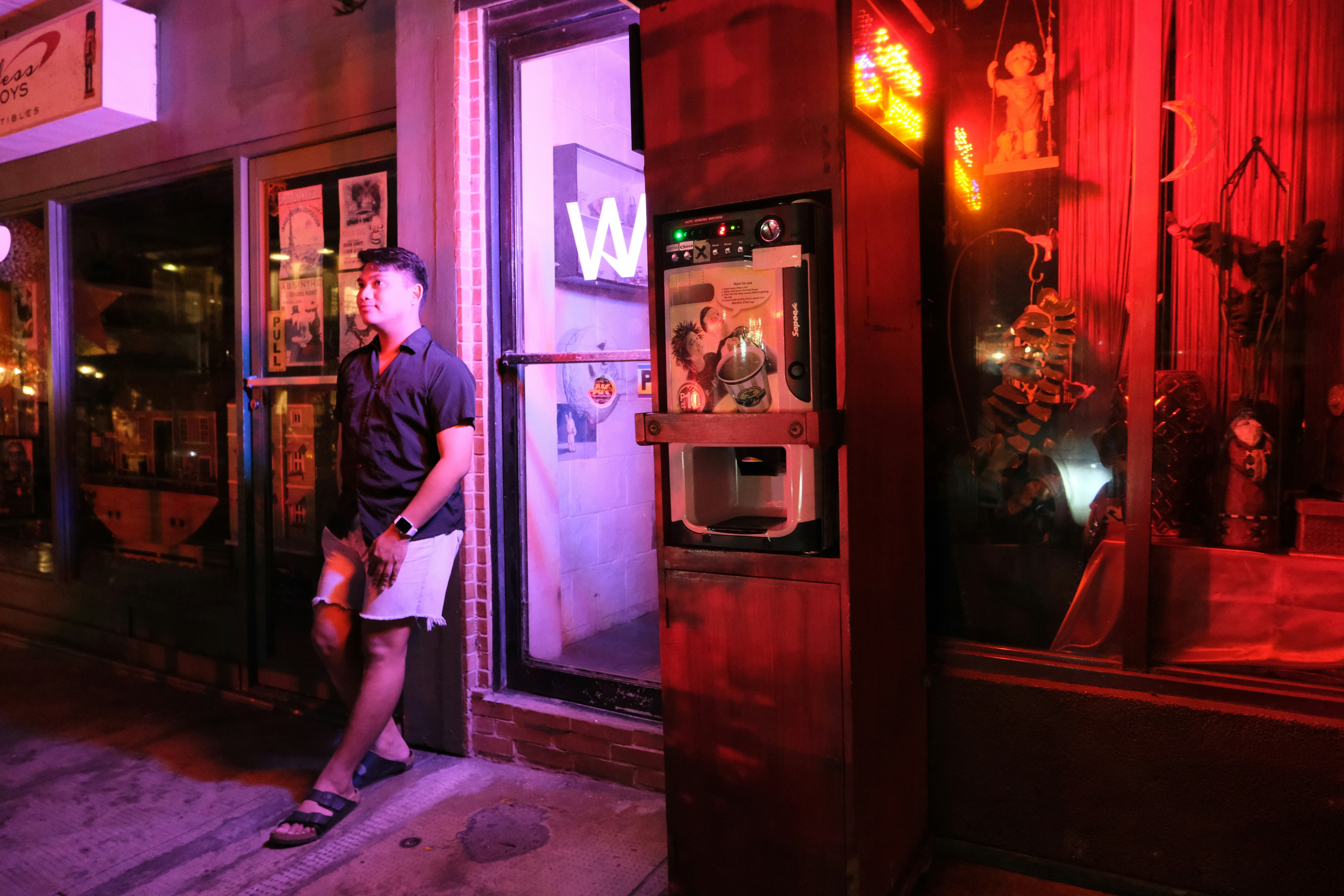 a man standing in front of a vending machine