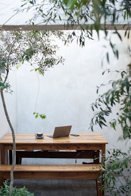 a wooden table with a laptop on top of it