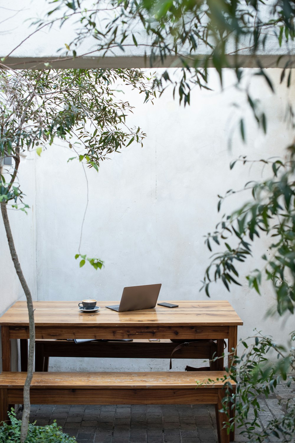 a wooden table with a laptop on top of it