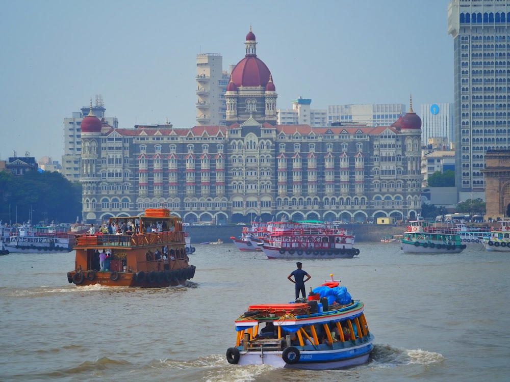 a large building is in the background with boats in the foreground