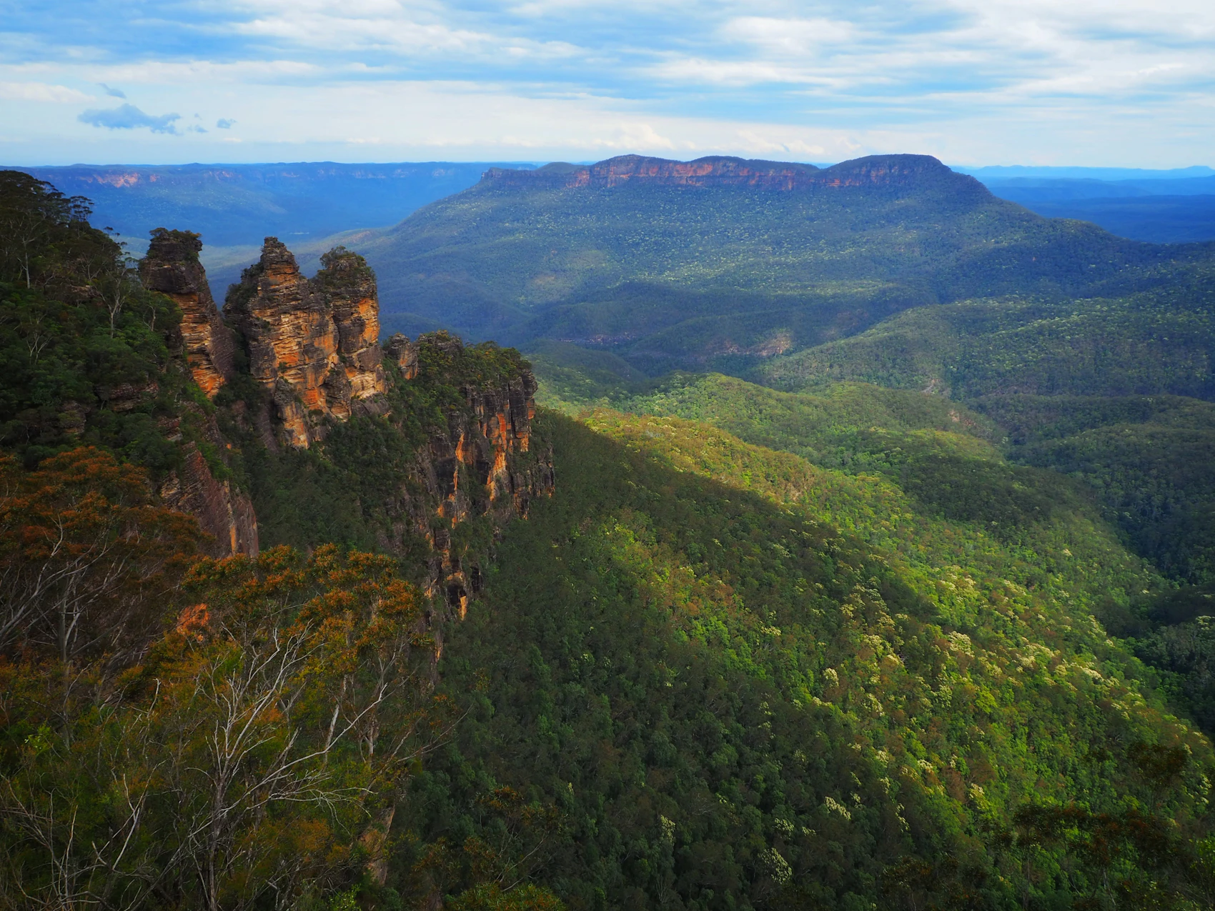 The Three Sisters rock formations above the forested Blue Mountains