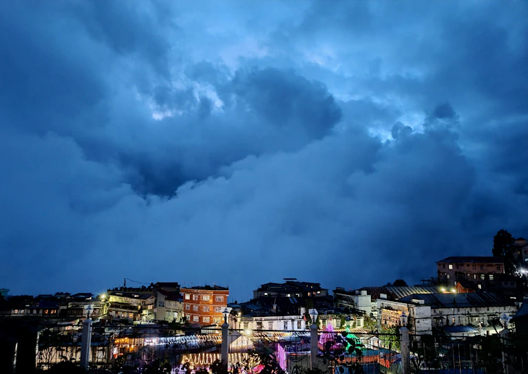 A vivid screenshot of Dark Saga's bustling town square filled with players and NPCs under a twilight sky.
