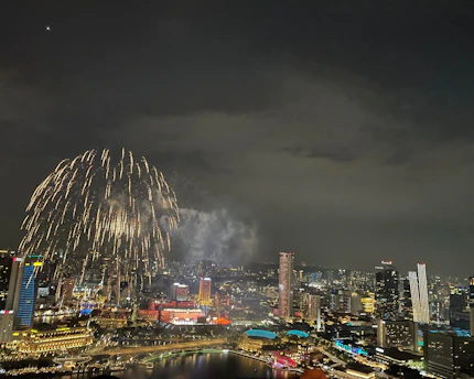A vibrant collage of Bollywood stars with sparkling city lights in the background.