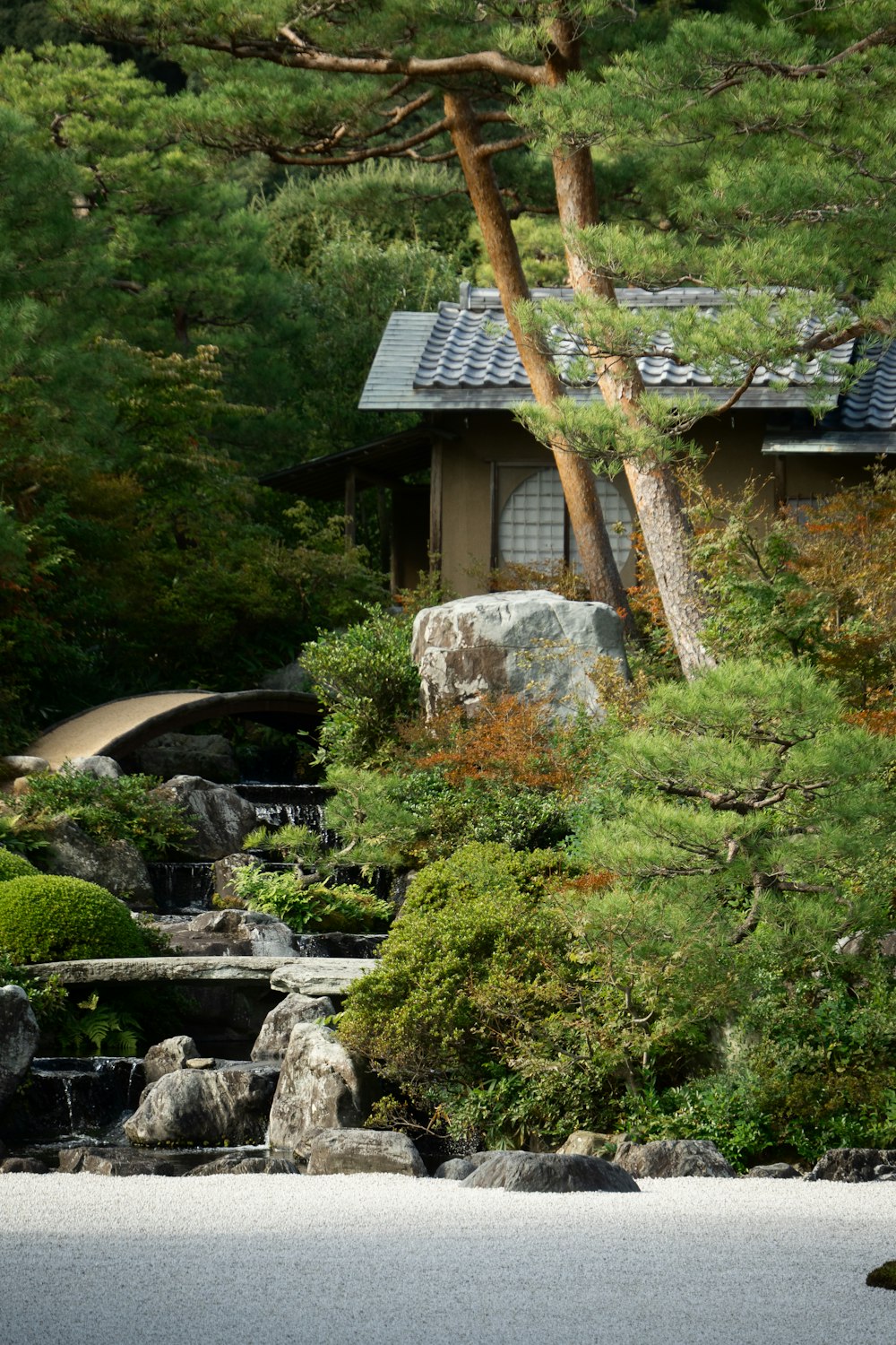 a small house surrounded by trees and rocks