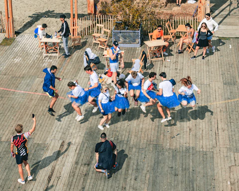 a group of people dressed in blue skirts