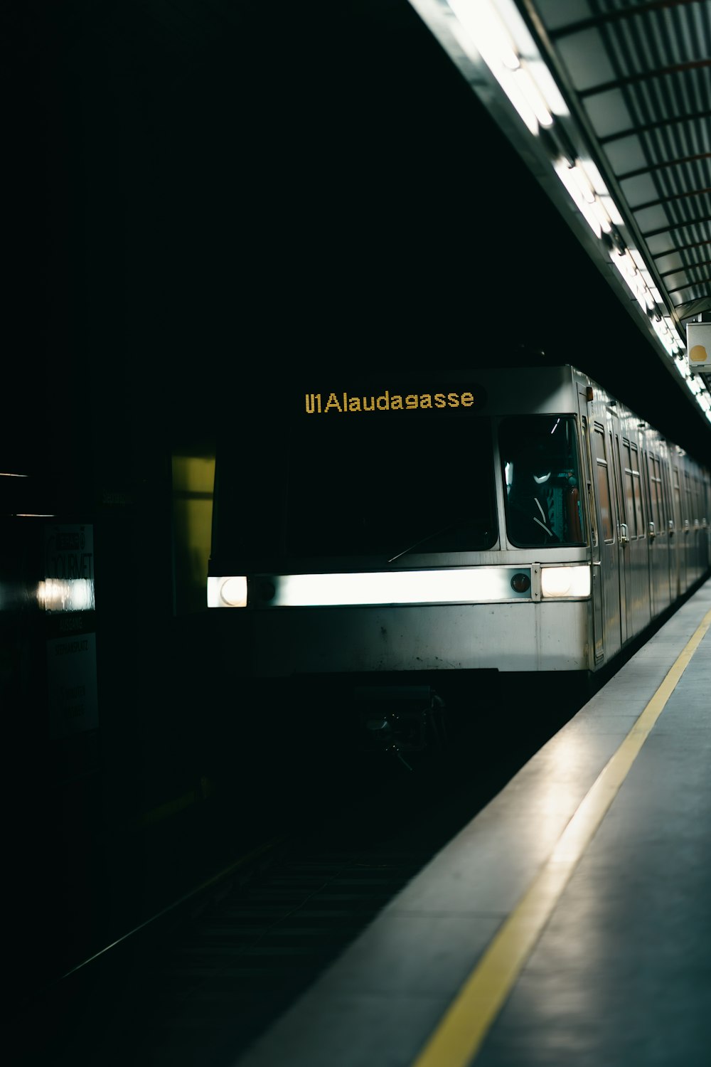 a train pulling into a train station at night