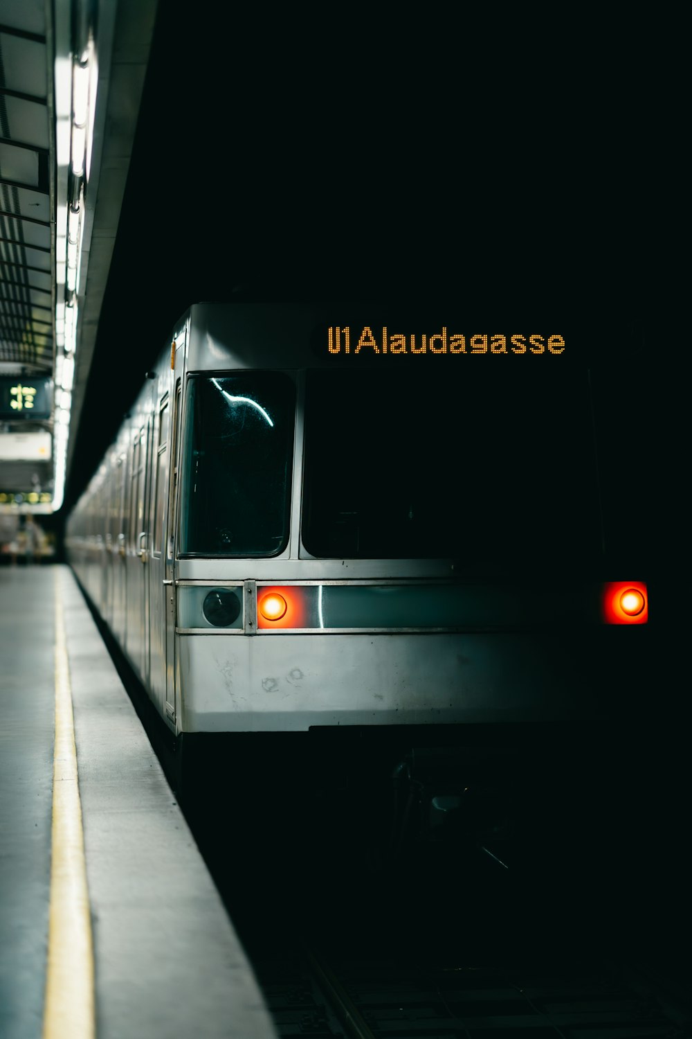 a subway train pulling into a train station