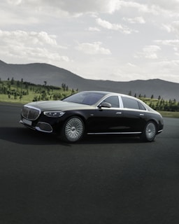 A stylish executive car on a scenic city road.