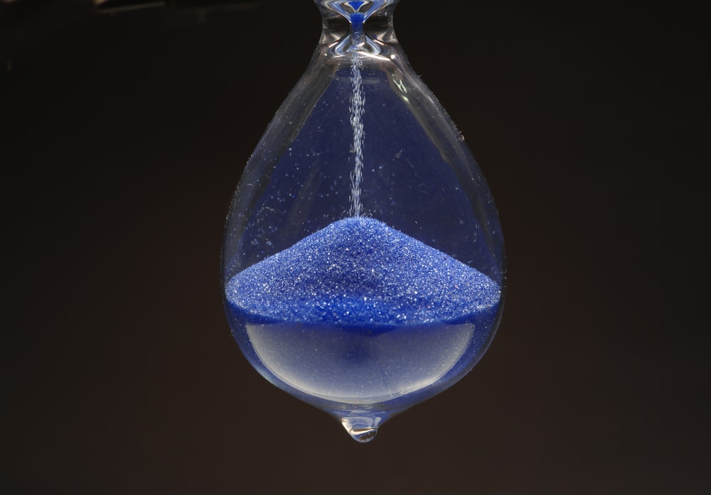 a blue substance in a glass hanging from a hook