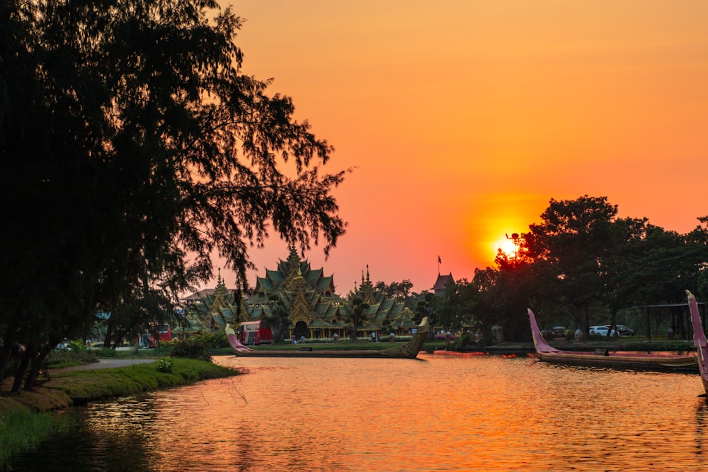 a sunset over a body of water with boats in it