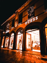 A welcoming storefront of a gdfthrs retail shop glowing in evening light