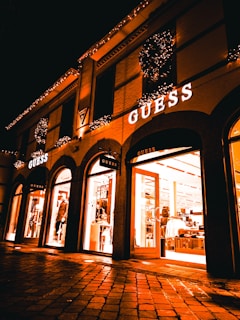 Evening shot of the upcoming tru gear bkny pop-up shop exterior with gold signage glowing against the night