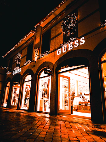 Elegant storefront with a glowing star logo at dusk