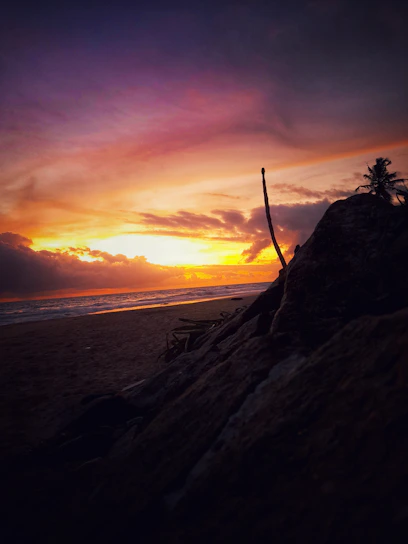 A stunning sunset over a Cape Verde beach with turquoise waters and soft sand.