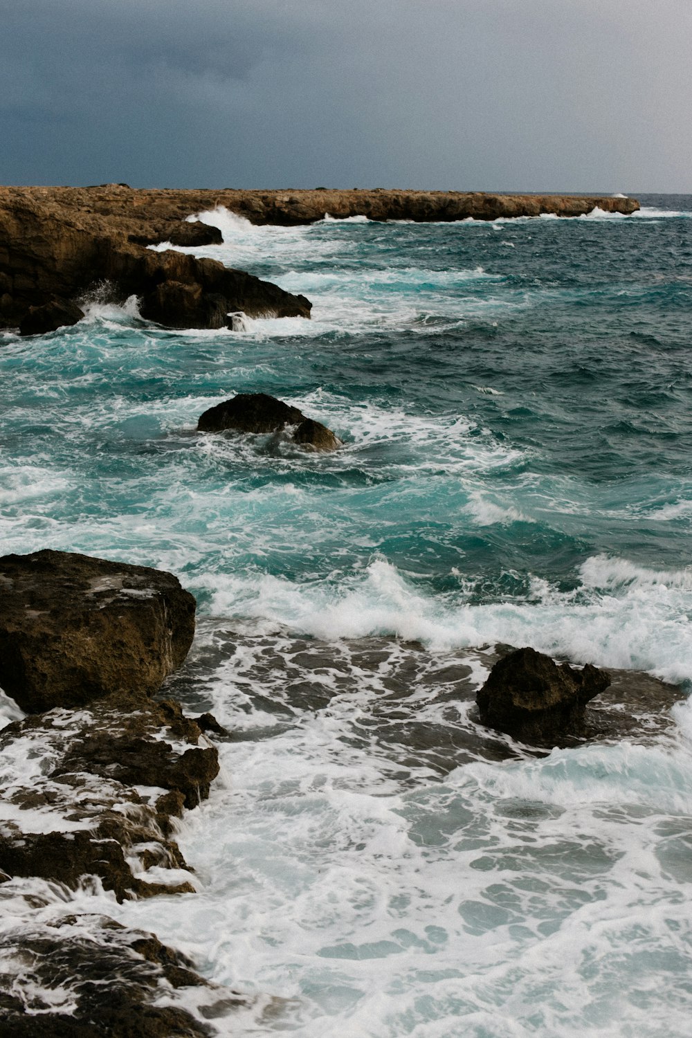 a couple of rocks that are in the water