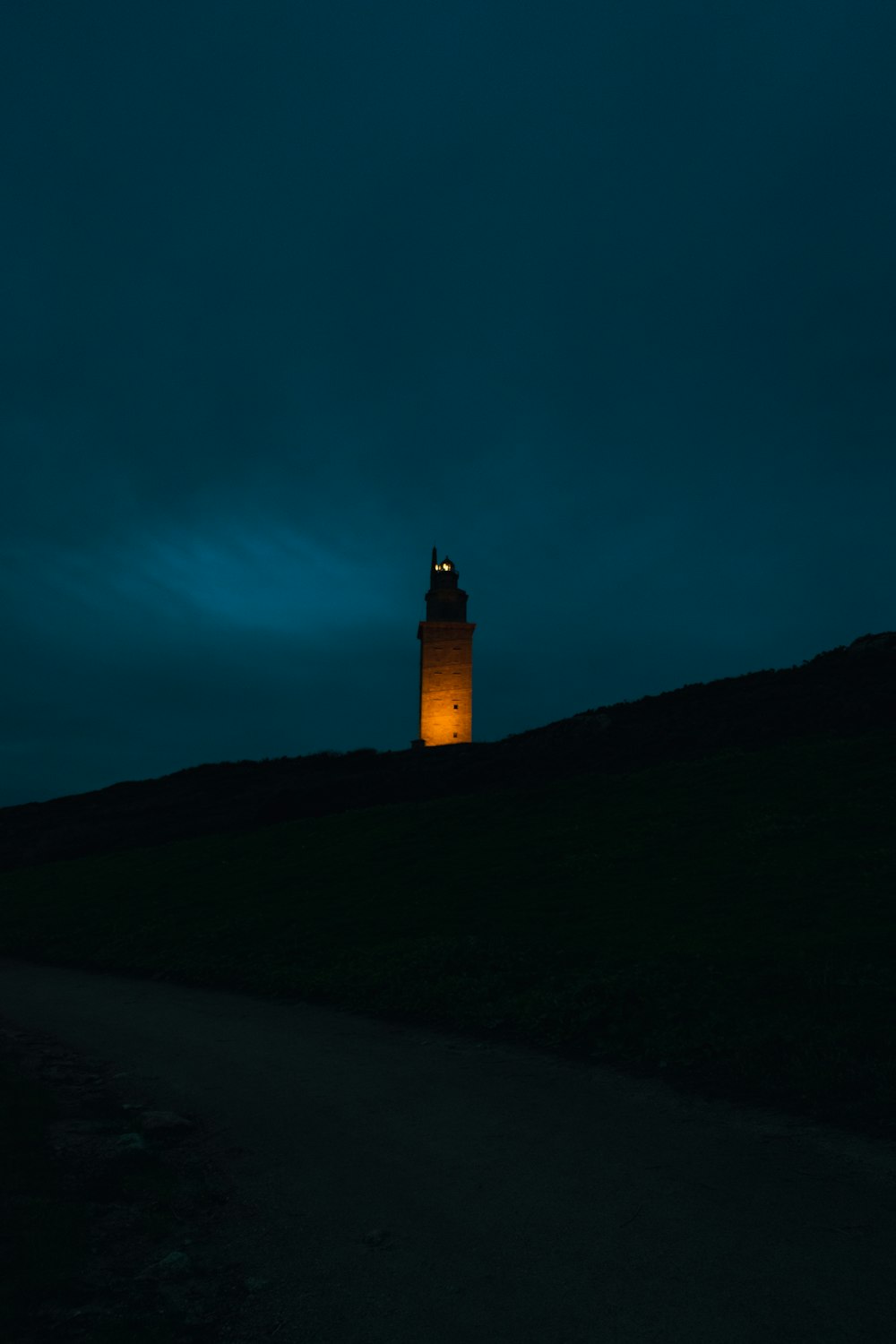 a tall clock tower sitting on the side of a hill