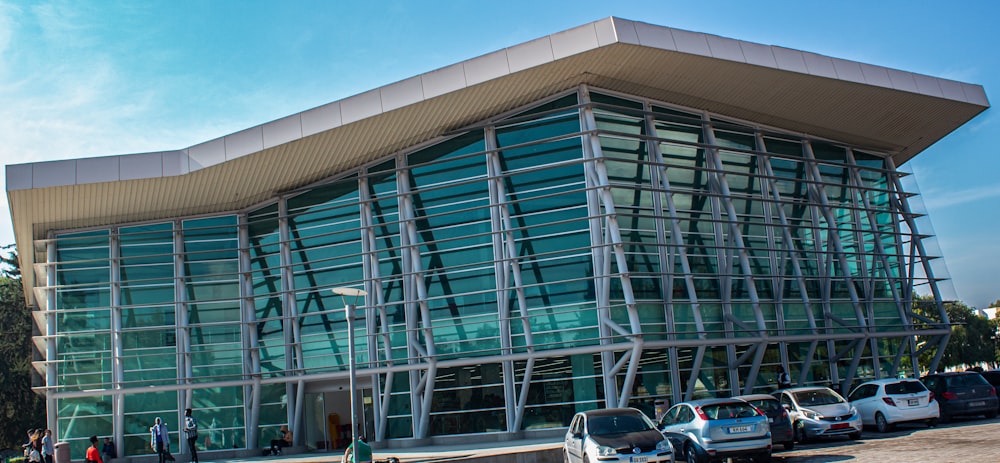 a large building with many cars parked in front of it