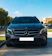 Black Mercedes-Benz Vito W447 minivan parked in front of Athens International Airport under clear skies.