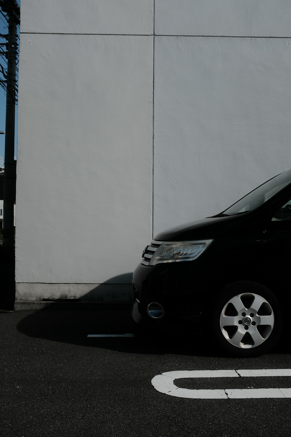 a black van parked in front of a white building