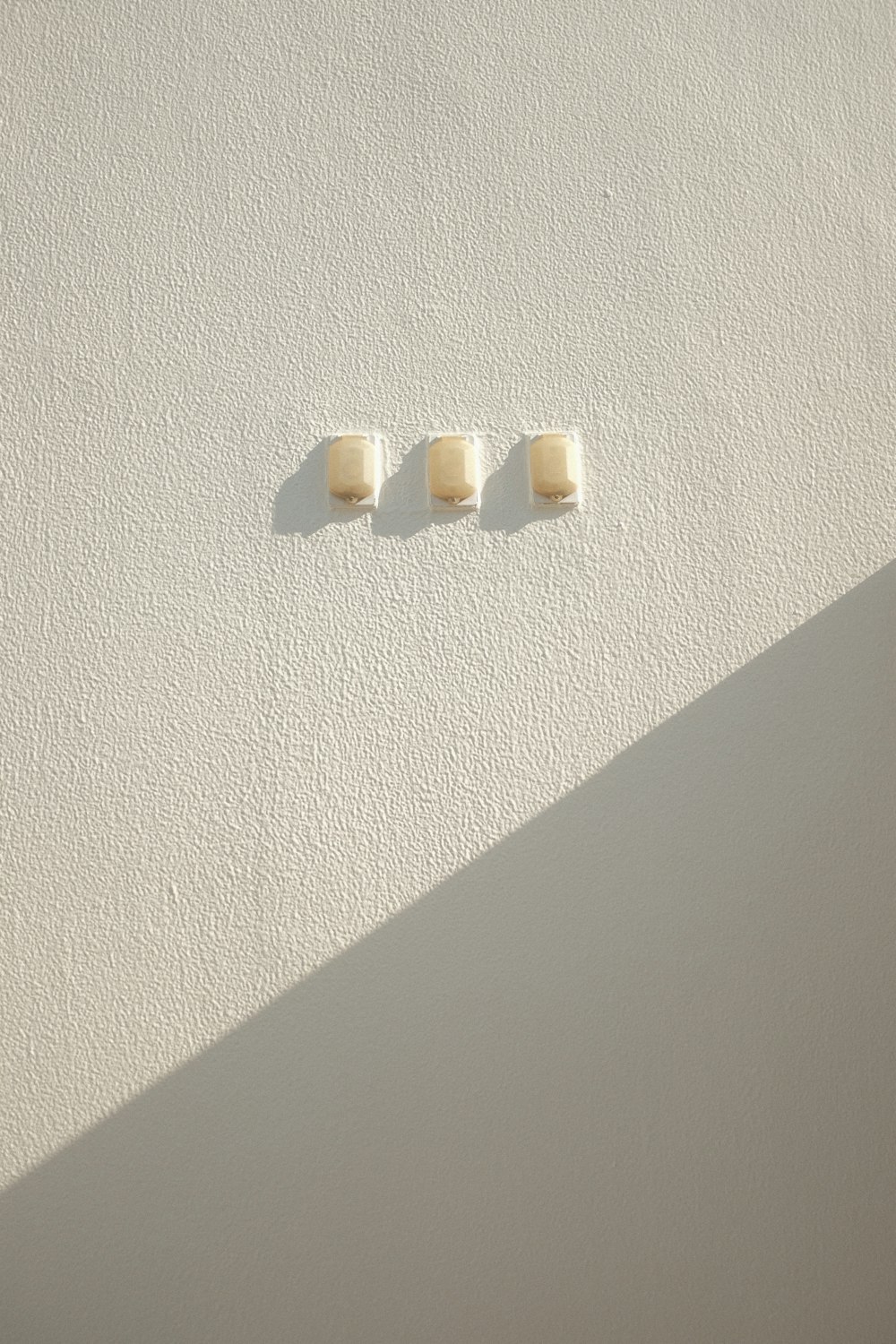 a couple of square pieces of food sitting on top of a white wall