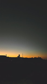Modern pharmaceutical manufacturing plant under construction at sunset