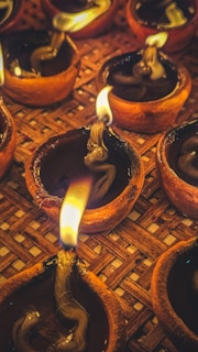 Handmade clay lamps glowing softly in a warm ambiance.