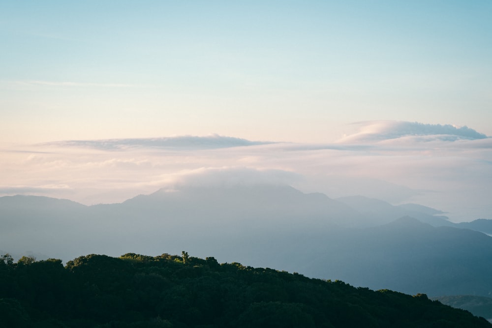 a view of a mountain range with clouds in the sky