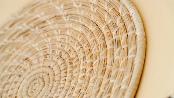 Close-up of a rural Karnataka artisan weaving a traditional basket with vibrant natural fibers.