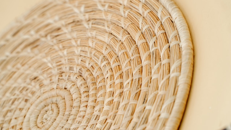 A close-up of a vibrant handwoven basket showcasing intricate Indonesian patterns.