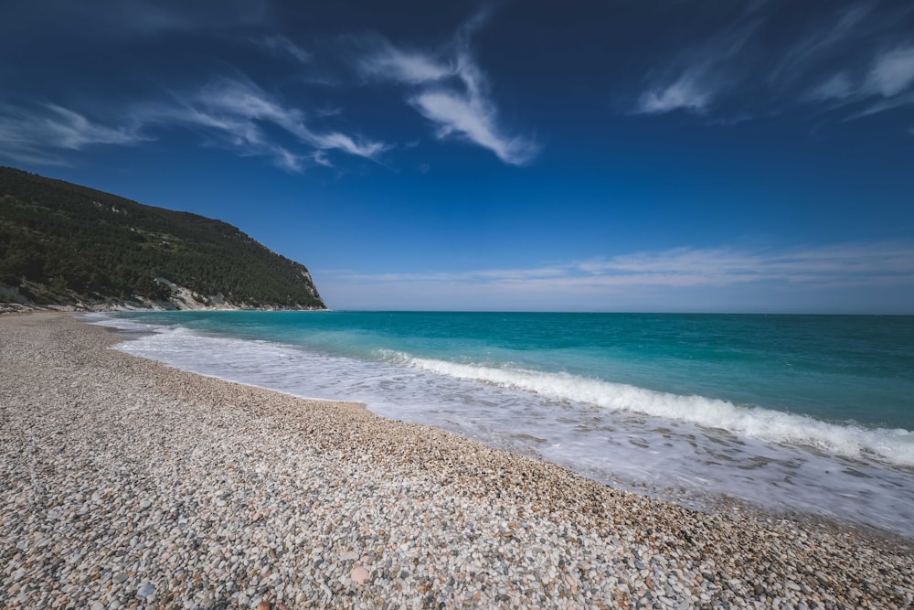 a sandy beach with waves coming in to the shore