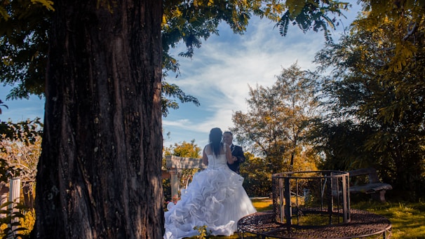 A videographer filming a joyful outdoor wedding ceremony in Georgia with lush greenery.