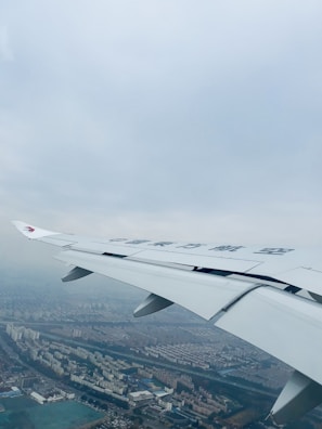 Aerial shot of a city skyline with an airplane flying overhead