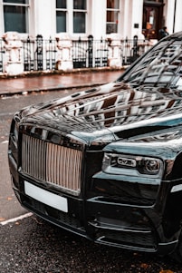a black car parked on the side of the road