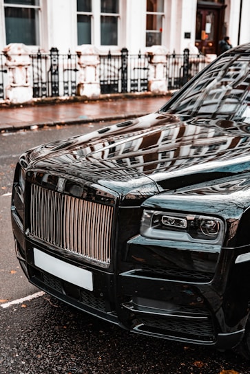 a black car parked on the side of the road