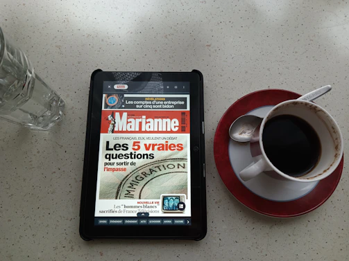 A digital tablet displaying a sleek flipbook interface of an old French magazine.