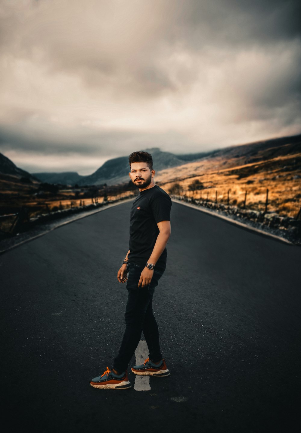 a man standing in the middle of a road