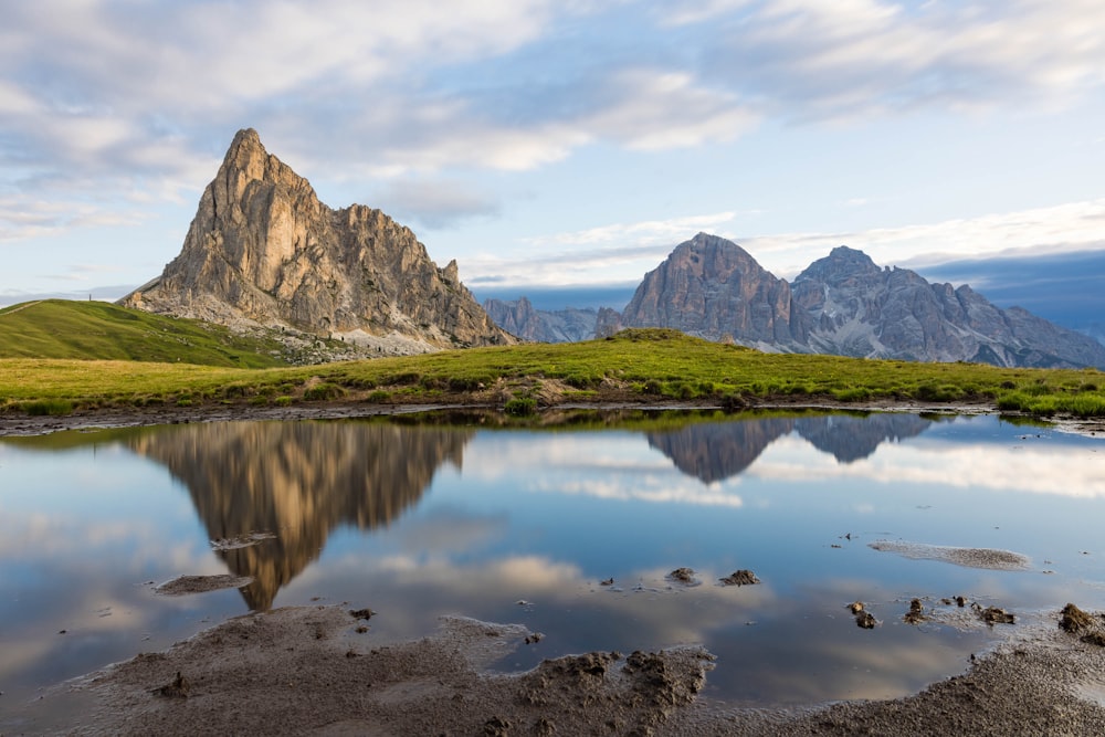 a mountain range with a body of water in the foreground