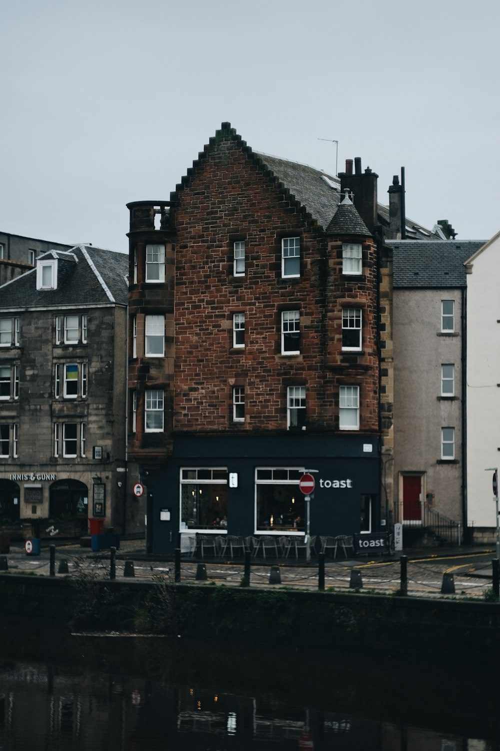 a row of buildings next to a body of water