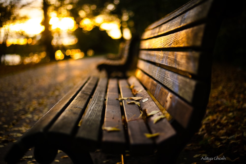 a wooden bench sitting in the middle of a park