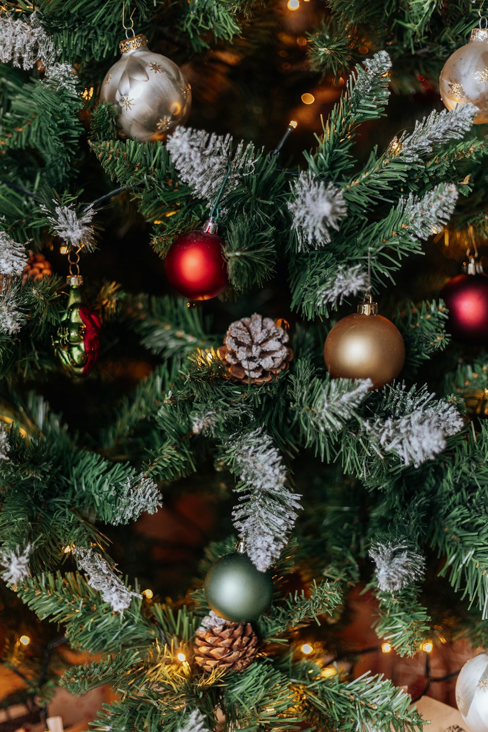 a close up of a christmas tree with ornaments