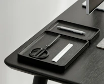 Close-up of hands assembling a sleek, modern office organizer.