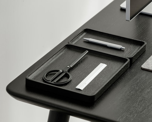 A set of sleek 3D printed desk organizers holding pens and notes neatly on a minimalist workspace.