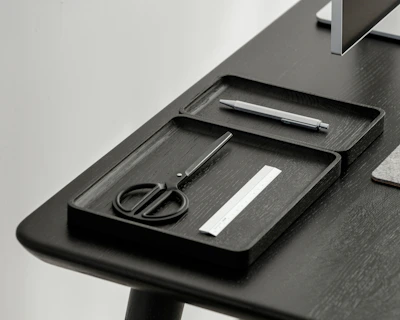 Close-up of hands assembling a sleek, modern office organizer.