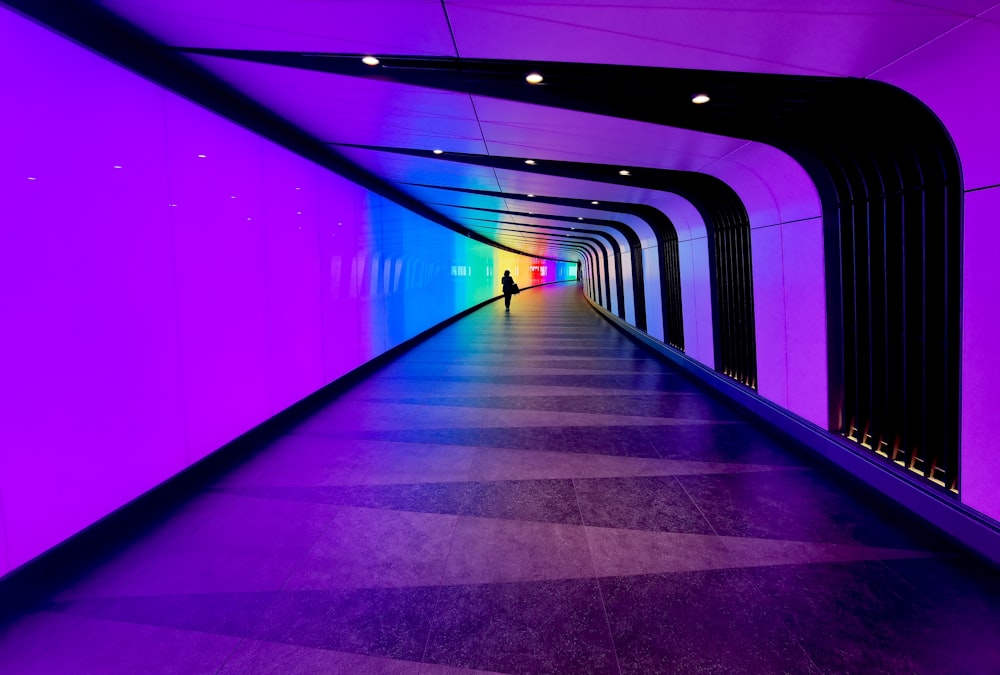 a person is walking down a long tunnel