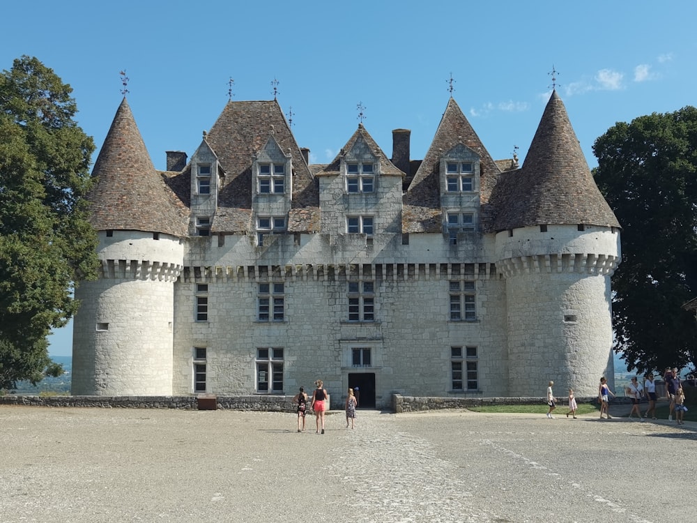 a castle with a lot of people standing outside of it