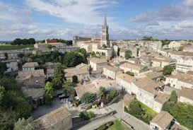 an aerial view of a city with a church tower