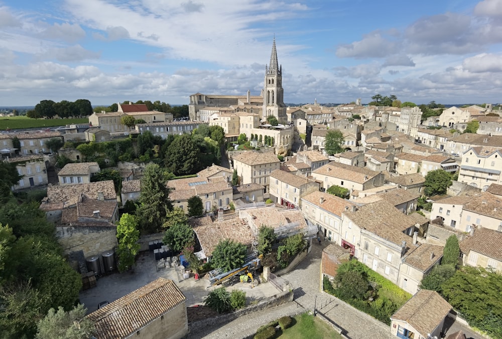 an aerial view of a city with a church tower