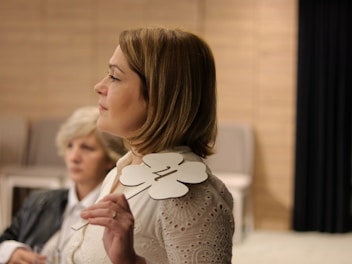 a woman standing next to another woman in a room